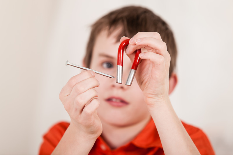 Get kids crazy-wild about science and math! The boys are playing with metal screws and magnets.
