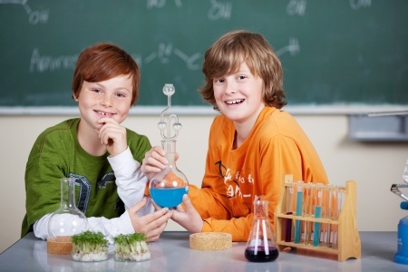 Two boys are creating a chemical science project for homeschool. Two boys are creating a chemical science project for homeschool.
