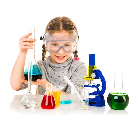 Hands-on science curriculum materials for kids Homeschool girl holding up chemistry equipment behind a microscope, beakers and flasks