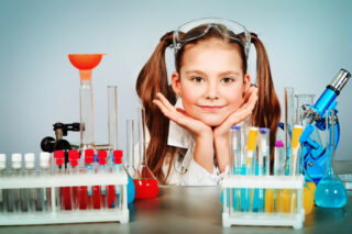 The girl is creating a chemical science project for homeschool The girl is creating a chemical science project for homeschool